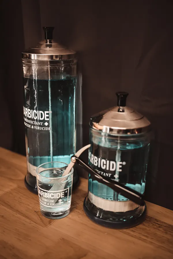 Barbicide disinfectant jars and a straight razor