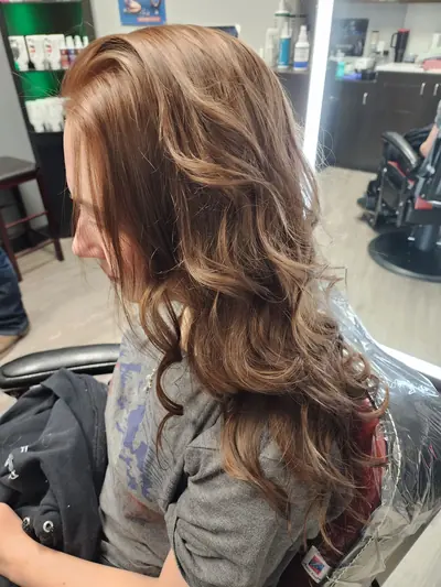 Long layered brunette cut with soft curls